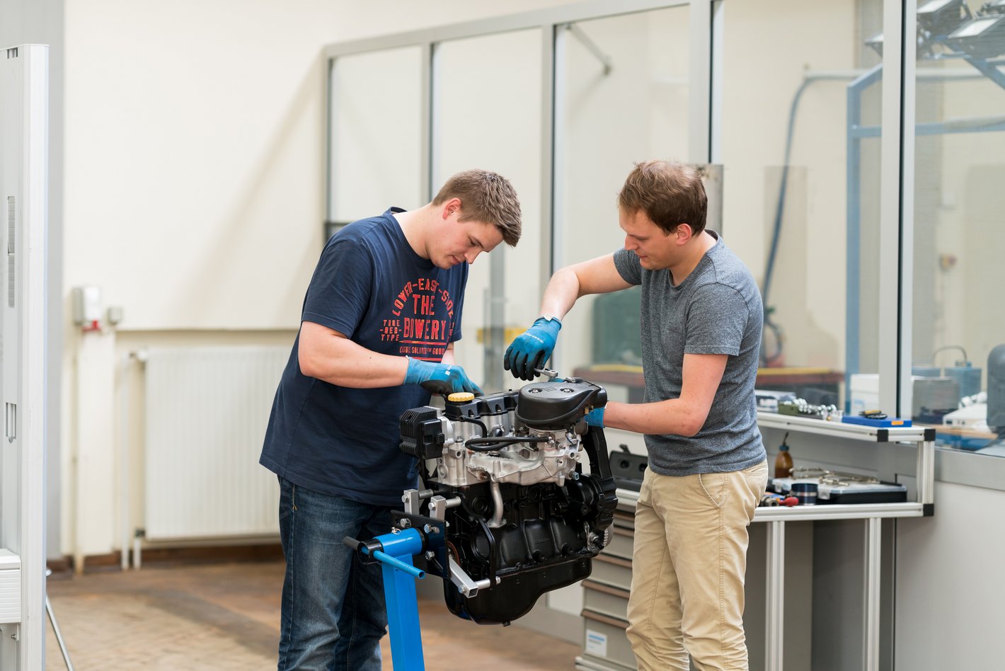 Two students working on a machine